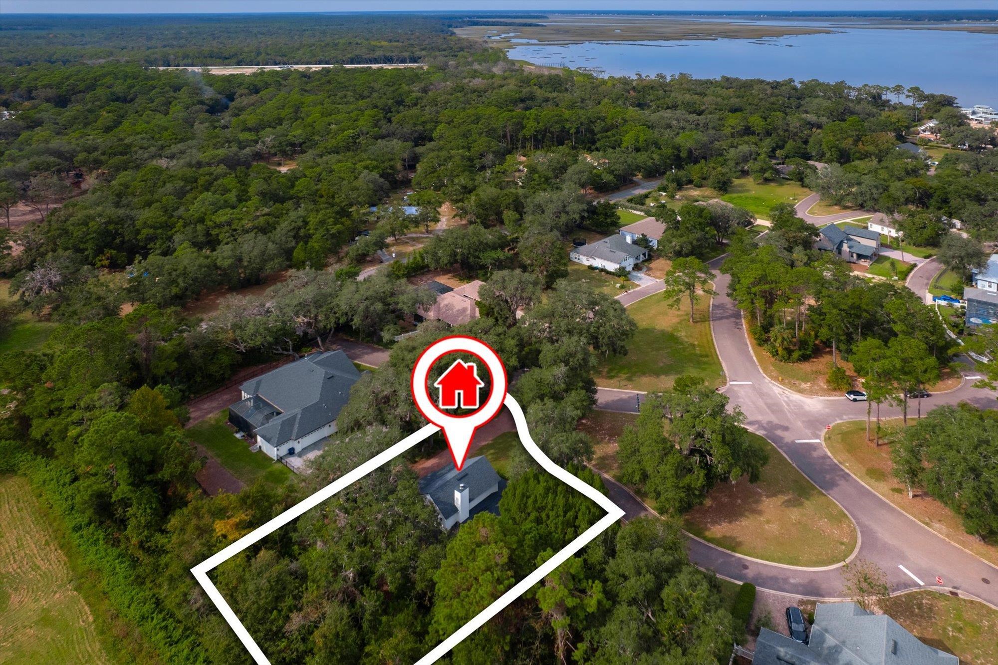 29318 Grandview Manor Yulee, FL 32097 - Photo 51 of 68 Aerial overview of property's location with a large body of water, property boundaries highlighted, and nearby suburban area