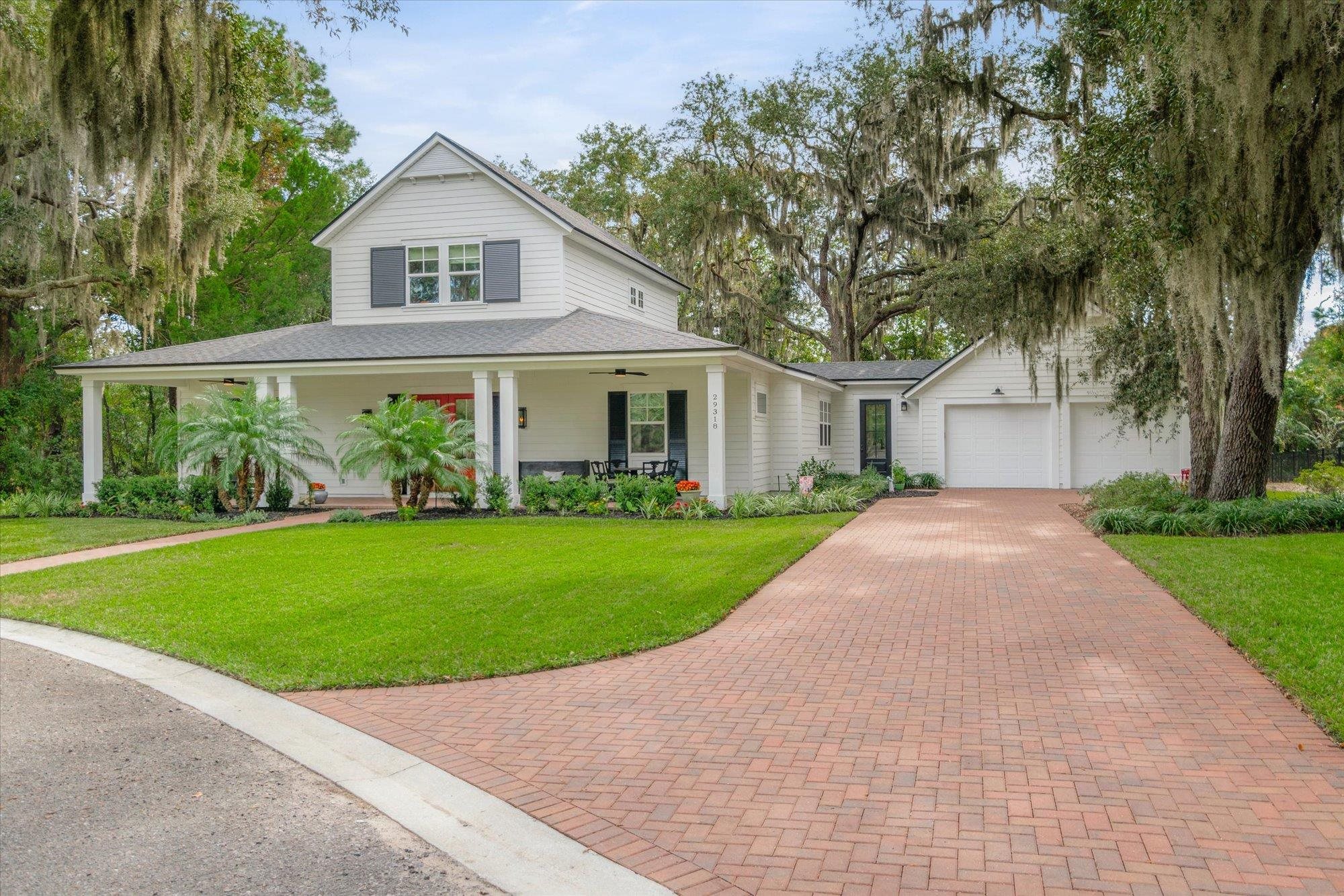 29318 Grandview Manor Yulee, FL 32097 - Photo 55 of 68 View of front of home featuring a porch, a front yard, a garage, a shingled roof, and decorative driveway