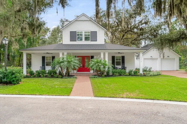 a front view of a house with a garden and plants