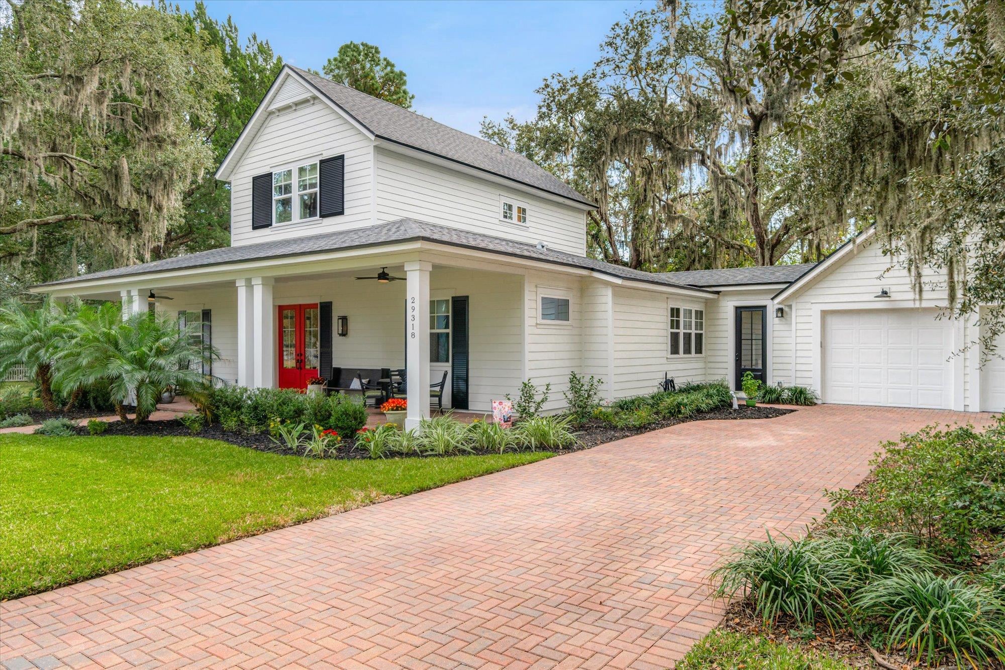 29318 Grandview Manor Yulee, FL 32097 - Photo 8 of 68 View of front of house featuring roof with shingles, a ceiling fan, a front yard, decorative driveway, and covered porch