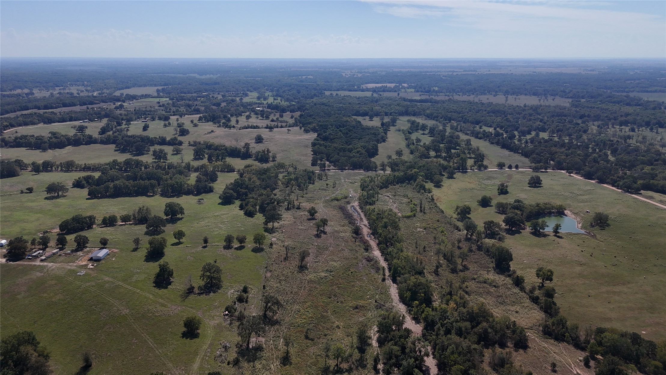 0 Sandy Creek Road Coleman, OK 73432 - Photo 9 of 9 Expansive acreage featuring a diverse landscape of fields and mature trees