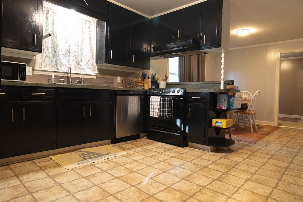 2811 16th Avenue Valley, AL 36854 - Photo 7 of 23 a kitchen with stainless steel appliances kitchen island granite countertop a refrigerator and a sink