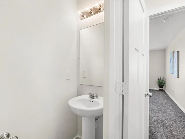 a bathroom with a sink a mirror and a shower