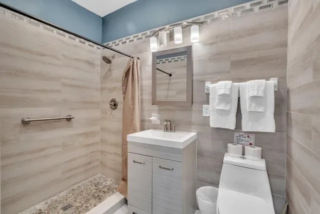 a spacious bathroom with a toilet and a shower