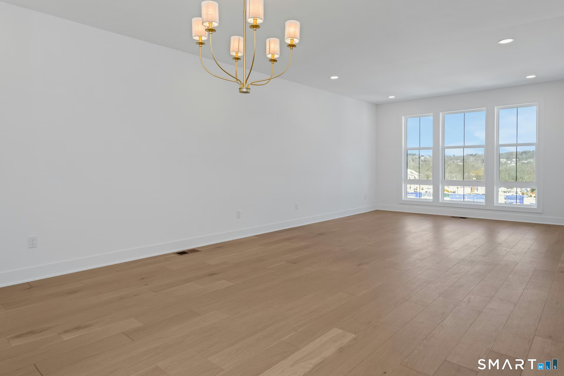 27 Bramble Way Brookfield, CT 06804 - Photo 12 of 26 an empty room with wooden floor and windows