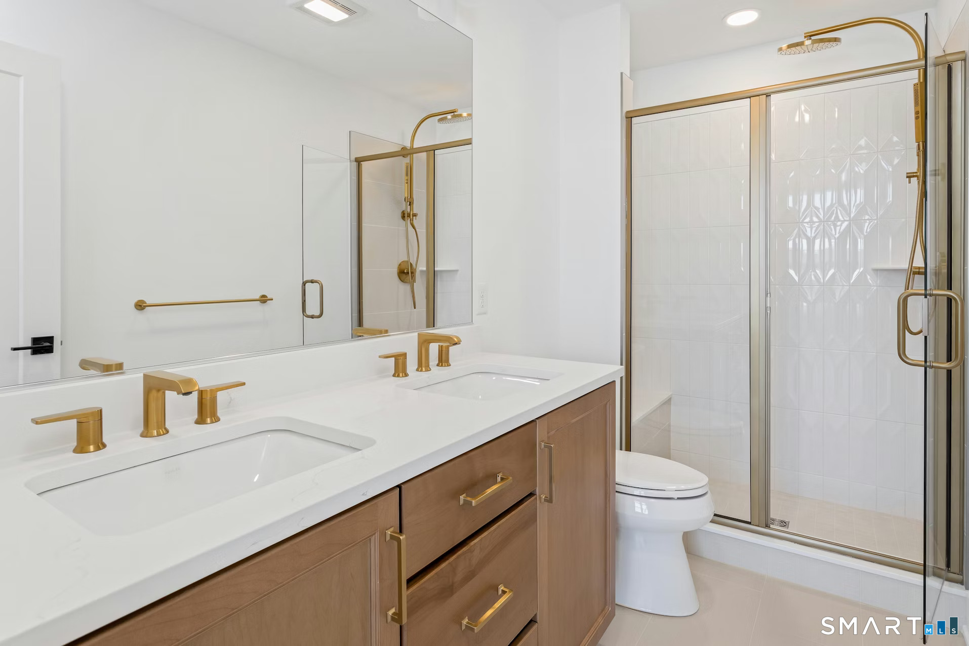 27 Bramble Way Brookfield, CT 06804 - Photo 19 of 26 a bathroom with a sink toilet a mirror and shower