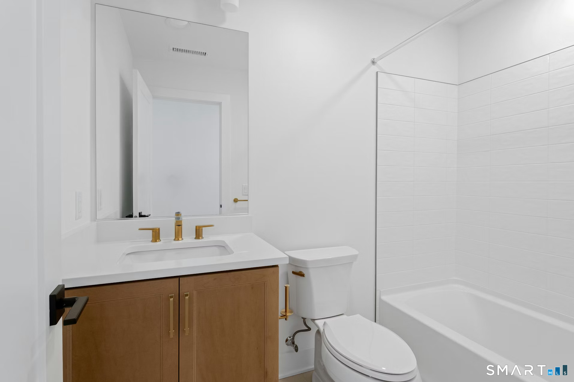 27 Bramble Way Brookfield, CT 06804 - Photo 20 of 26 a bathroom with a sink vanity mirror and toilet