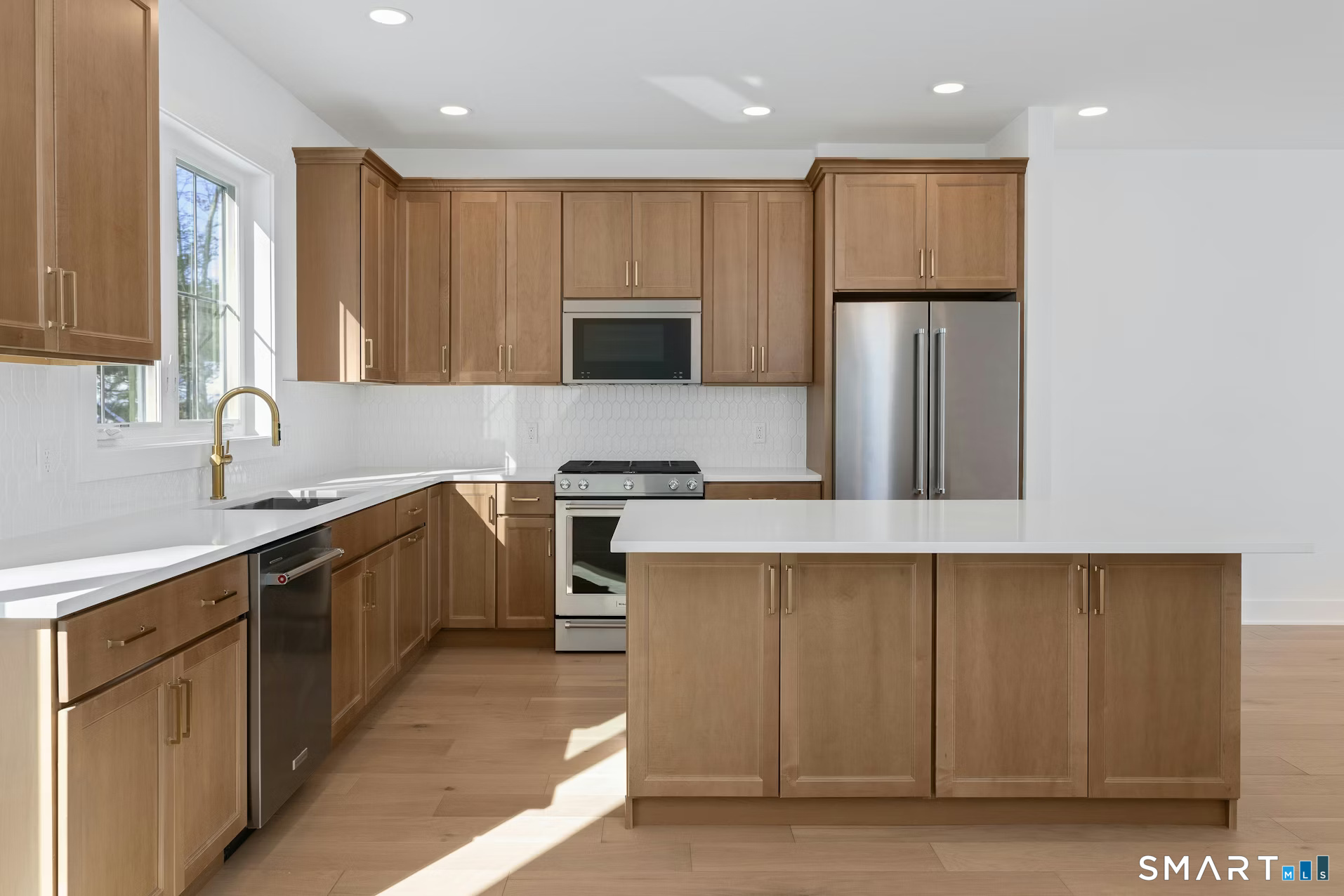 27 Bramble Way Brookfield, CT 06804 - Photo 4 of 26 a kitchen with a refrigerator and a sink