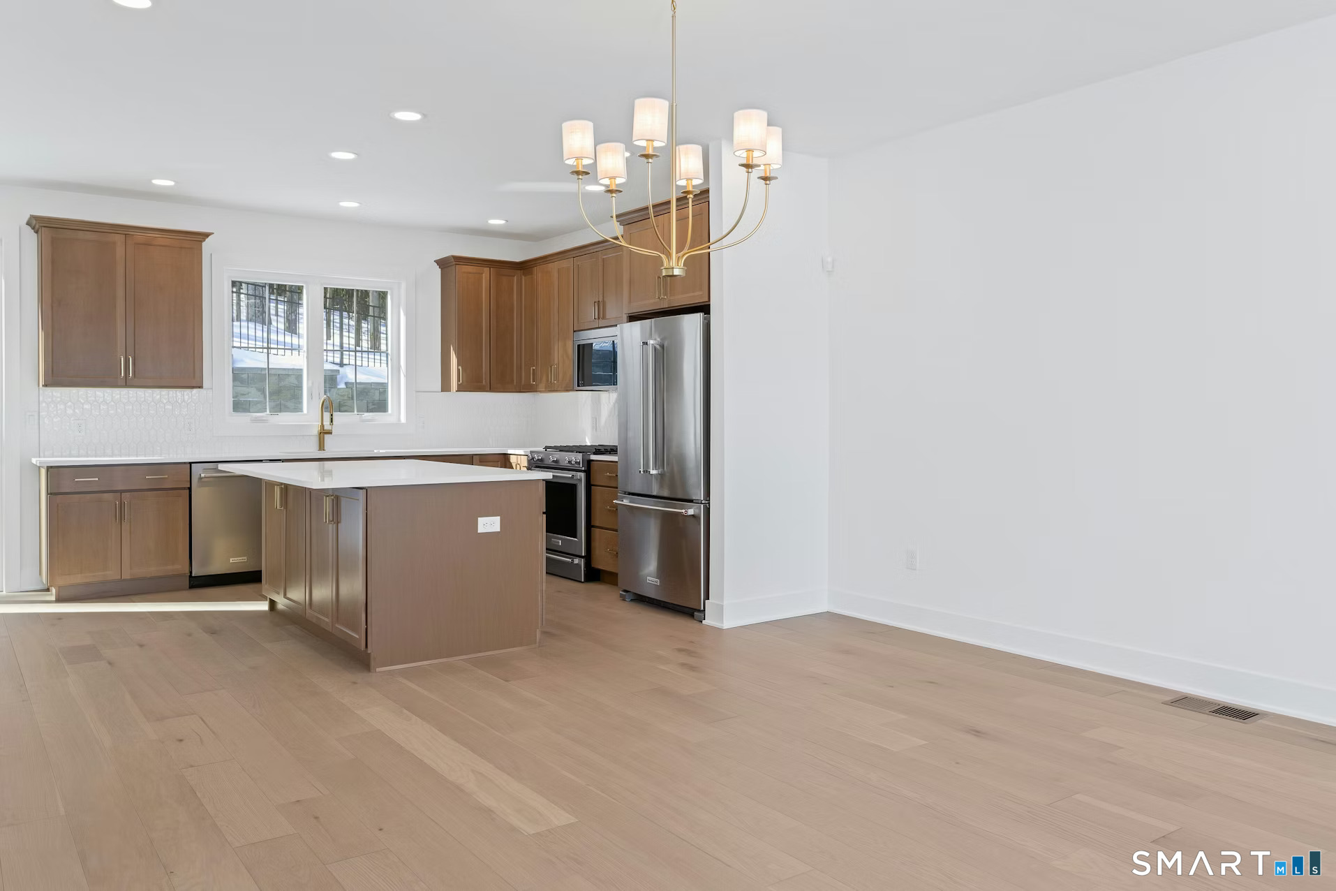 27 Bramble Way Brookfield, CT 06804 - Photo 9 of 26 a kitchen with stainless steel appliances granite countertop a refrigerator a sink dishwasher a stove with white cabinets