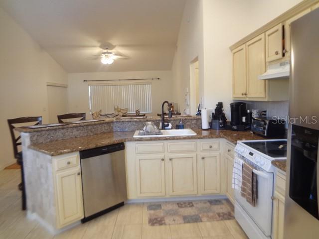 124 Foster Lane Palm Coast, FL 32137 - Photo 11 of 23 a kitchen with a sink stove and cabinets