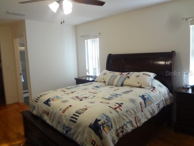 124 Foster Lane Palm Coast, FL 32137 - Photo 13 of 23 a bedroom with a bed and a chandelier