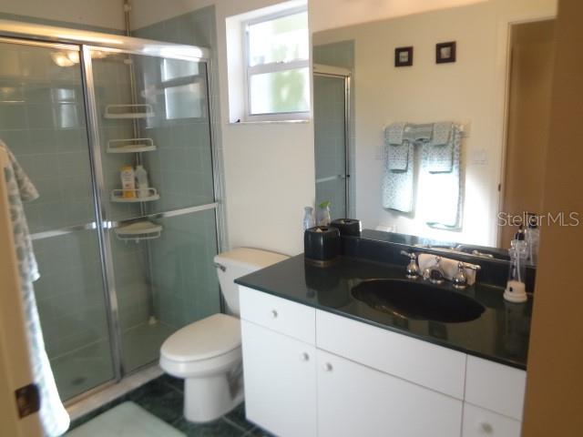 124 Foster Lane Palm Coast, FL 32137 - Photo 17 of 23 a bathroom with a sink a toilet a mirror and shower
