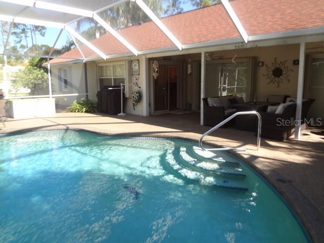 124 Foster Lane Palm Coast, FL 32137 - Photo 20 of 23 a backyard of a house with yard and outdoor seating