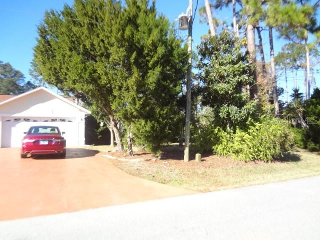 124 Foster Lane Palm Coast, FL 32137 - Photo 2 of 23 a view of road with a building