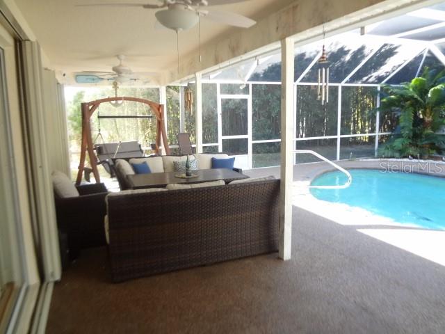 124 Foster Lane Palm Coast, FL 32137 - Photo 22 of 23 a living room with furniture and floor to ceiling window