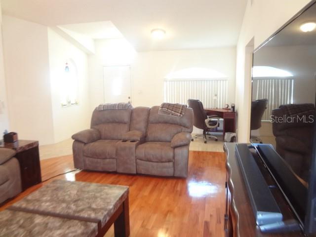 124 Foster Lane Palm Coast, FL 32137 - Photo 5 of 23 a living room with furniture and a flat screen tv