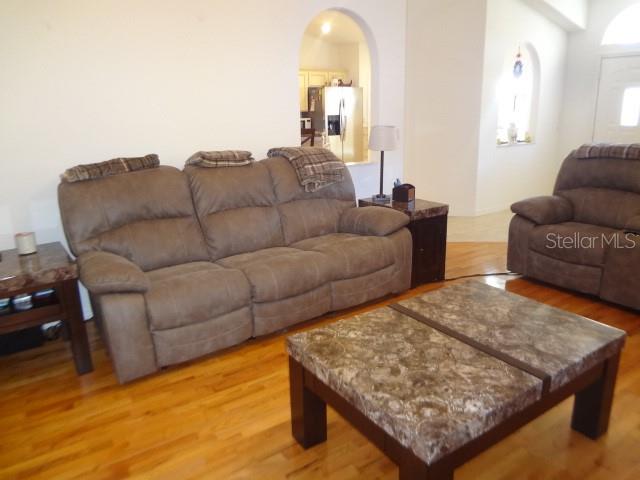 124 Foster Lane Palm Coast, FL 32137 - Photo 6 of 23 a living room with furniture and a wooden floor