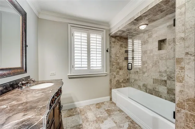 a bathroom with a granite countertop sink a toilet and bathtub