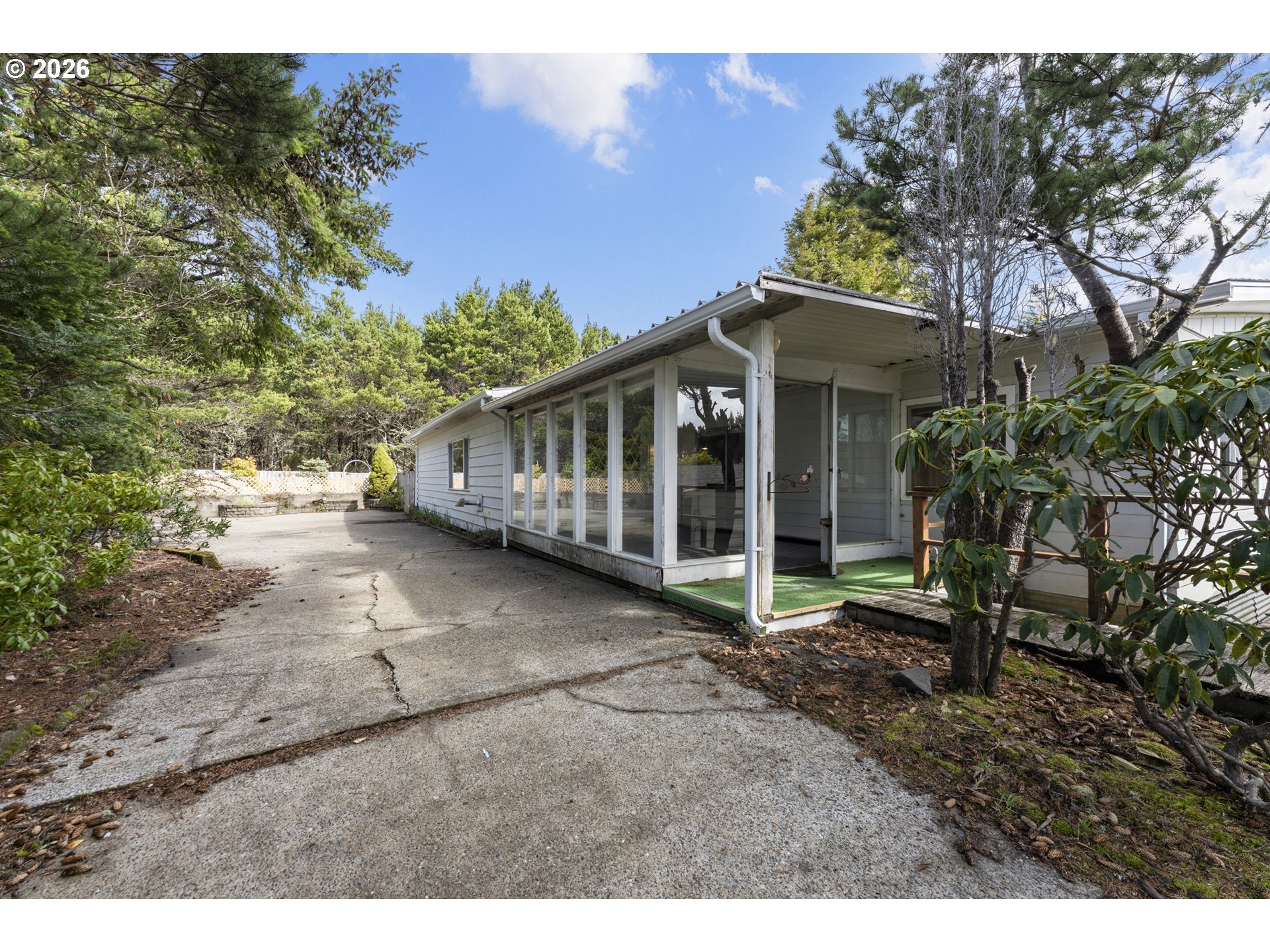 1600 Rhododendron Drive, Unit 415 Florence, OR 97439 - Photo 24 of 29 a view of a house with a yard