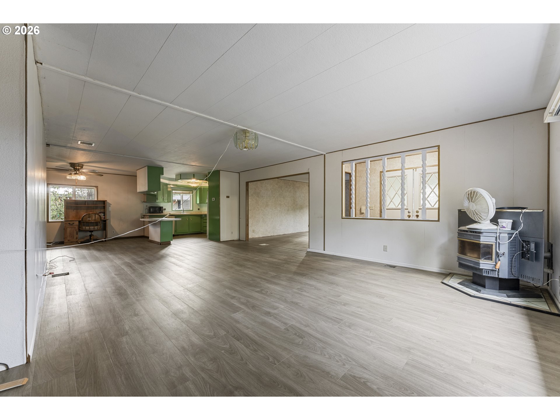 1600 Rhododendron Drive, Unit 415 Florence, OR 97439 - Photo 26 of 29 a view of a livingroom with furniture a window and wooden floor