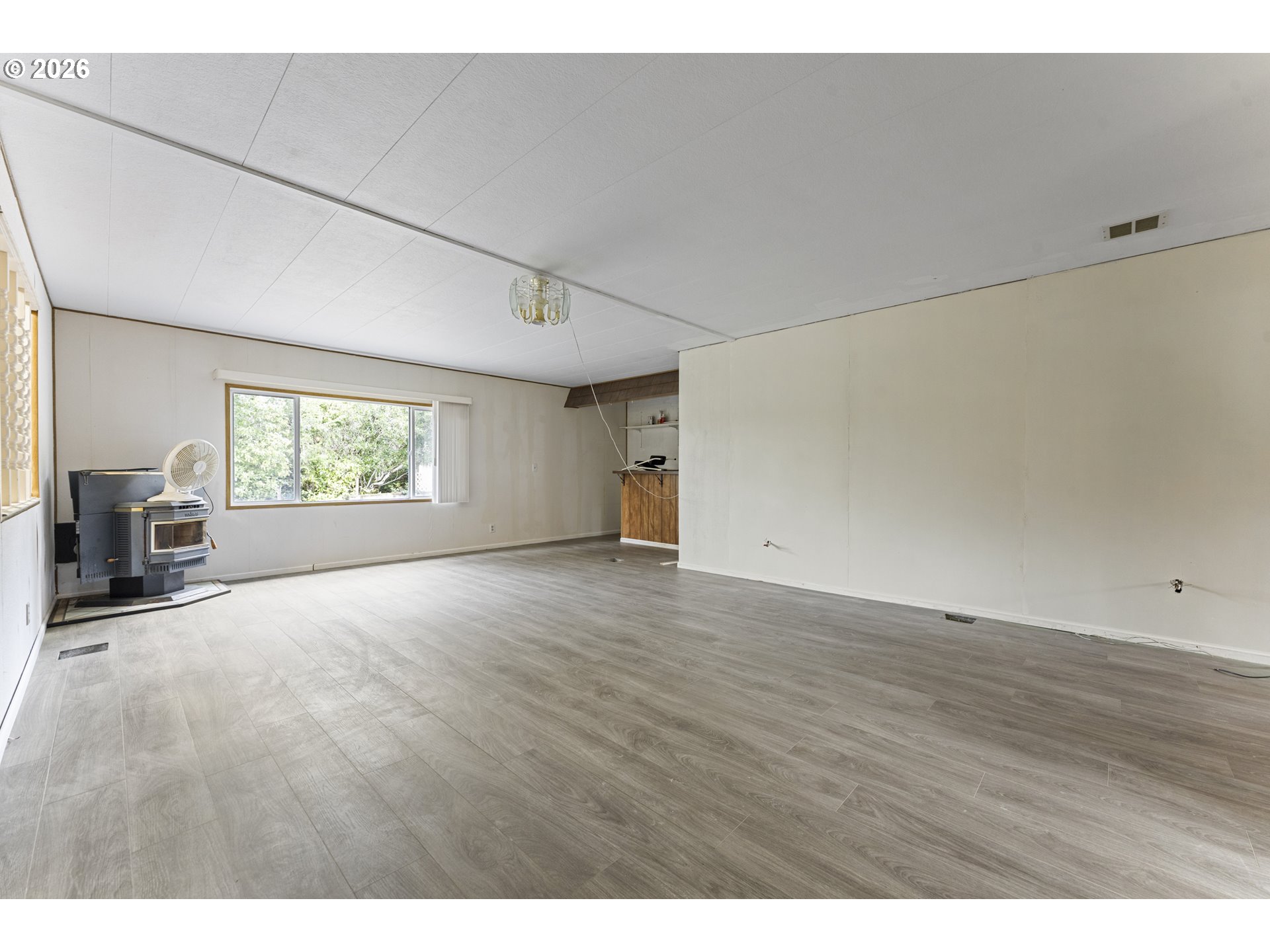 1600 Rhododendron Drive, Unit 415 Florence, OR 97439 - Photo 27 of 29 a view of empty room with wooden floor and fan