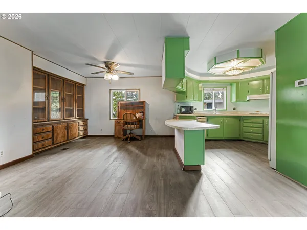 a kitchen with a sink cabinets and wooden floor