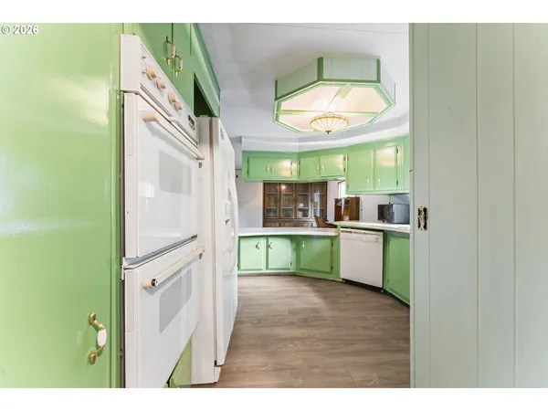 a kitchen with stainless steel appliances granite countertop a sink and a large mirror