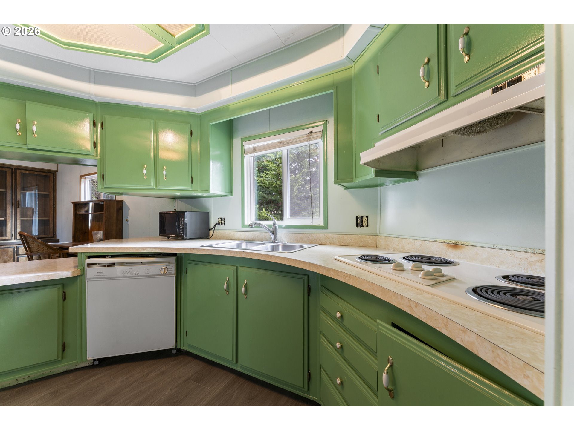 1600 Rhododendron Drive, Unit 415 Florence, OR 97439 - Photo 5 of 29 a kitchen with a sink and cabinets