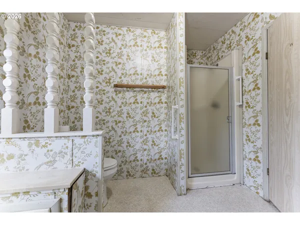 a bathroom with a shower and a sink