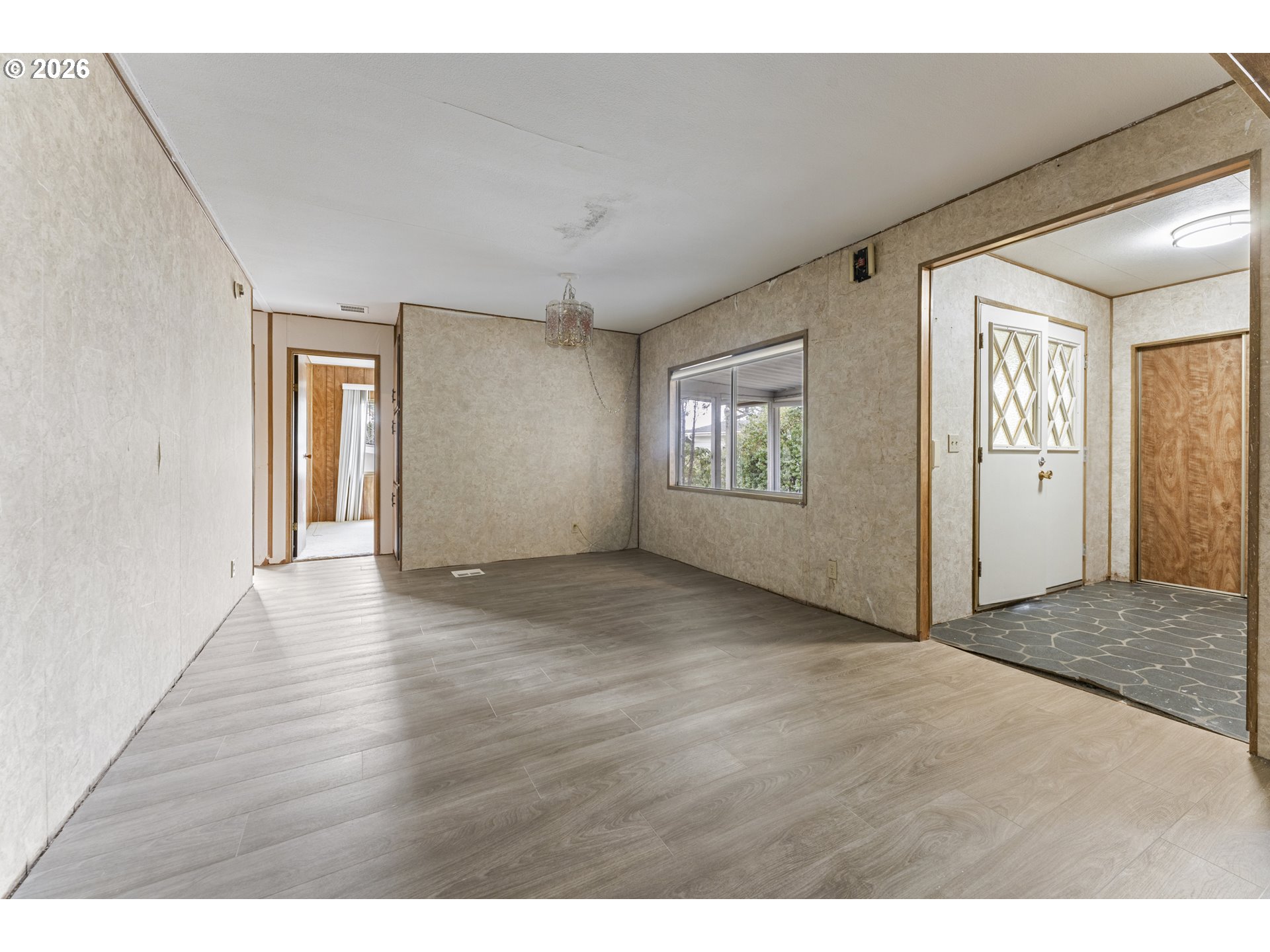 1600 Rhododendron Drive, Unit 415 Florence, OR 97439 - Photo 10 of 29 a view of an empty room with wooden floor and a window