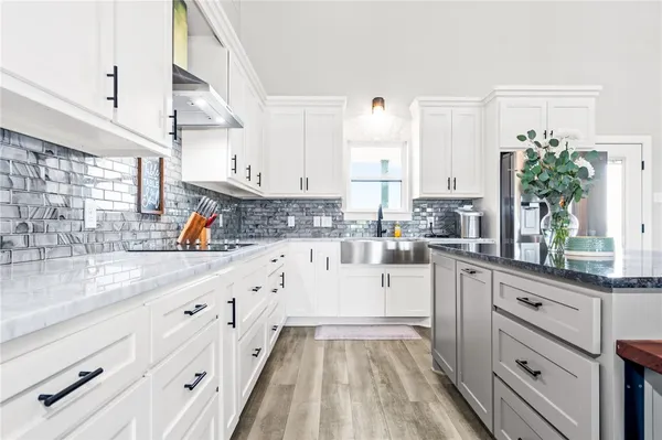 a kitchen with white cabinets and a sink