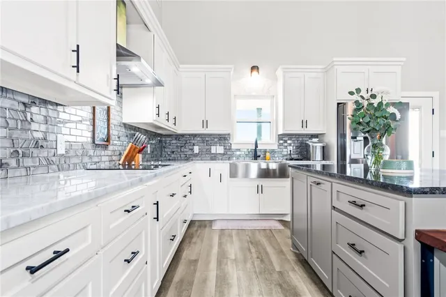 a kitchen with white cabinets and a sink