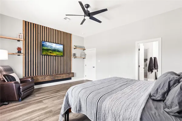 a bedroom with a bed and a view of a chandelier