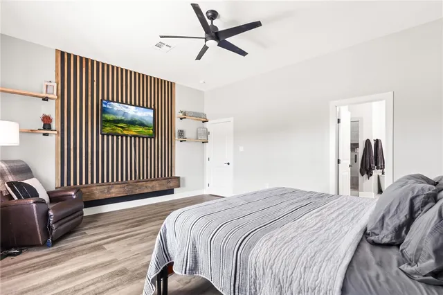 a bedroom with a bed and a view of a chandelier