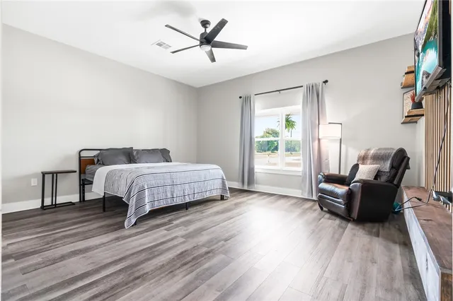 a bedroom with a bed a couch and a window