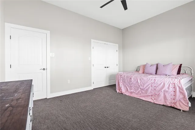 a spacious bedroom with a bed and a dresser