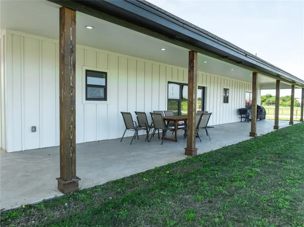 a view of a porch with chairs and backyard