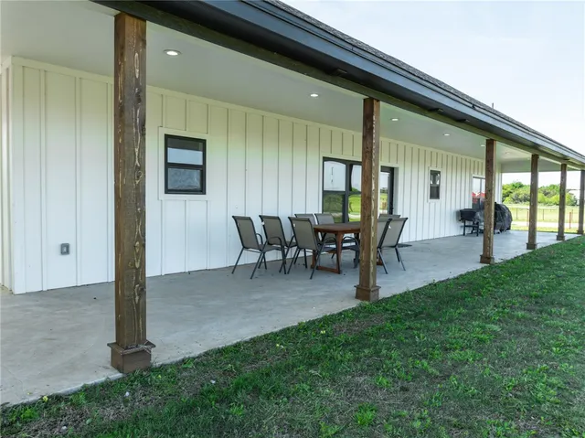 a view of a porch with chairs and backyard