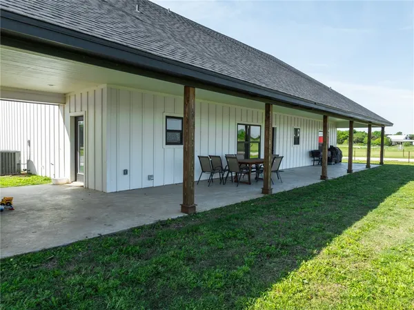 a view of a porch with chairs and backyard