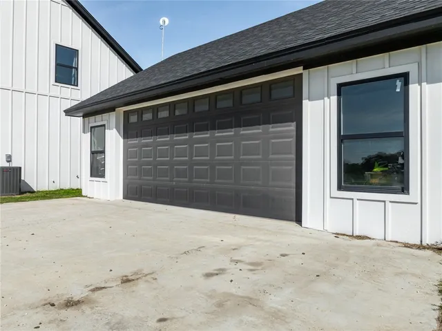 a swimming pool with lawn chairs and plants