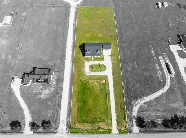 a backyard of a house with a yard and outdoor seating