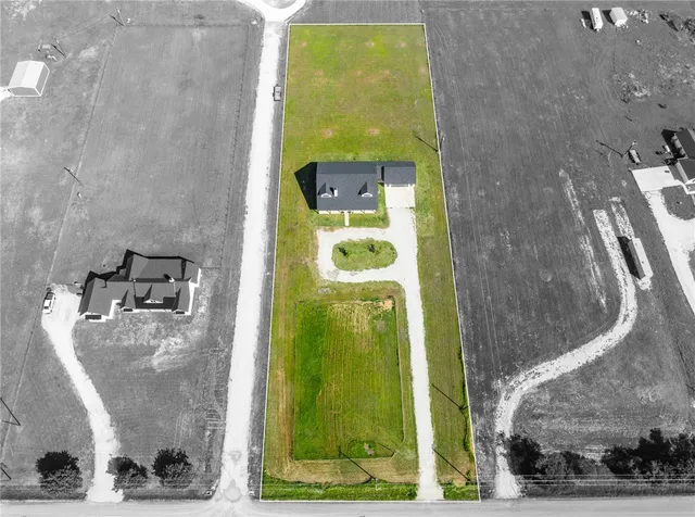 a backyard of a house with a yard and outdoor seating