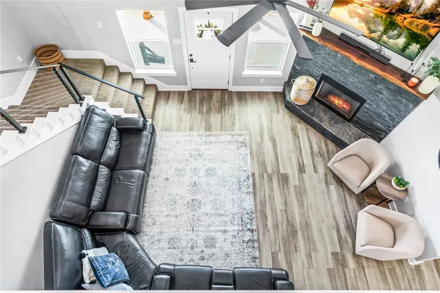 a living room with furniture and a wooden floor