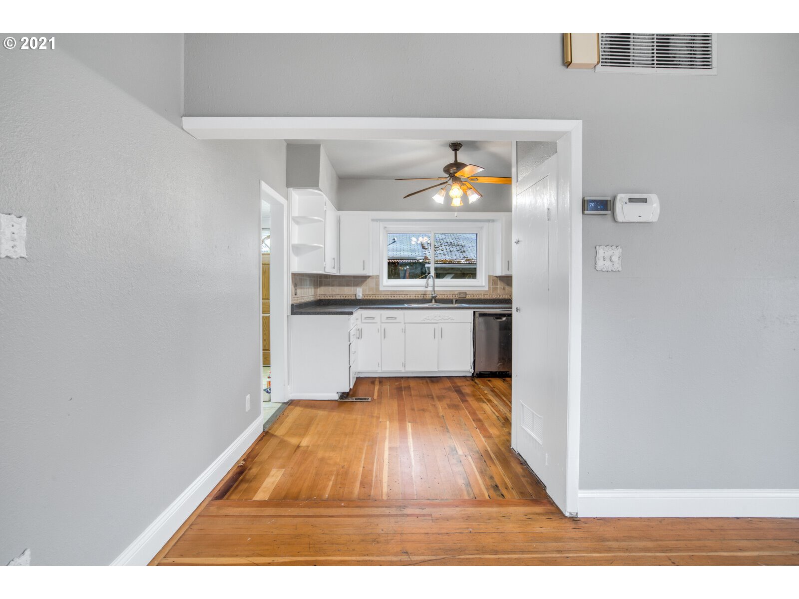 1215 2nd Street Northwest Salem, OR 97304 - Photo 13 of 32 a kitchen with stainless steel appliances granite countertop a sink and a stove