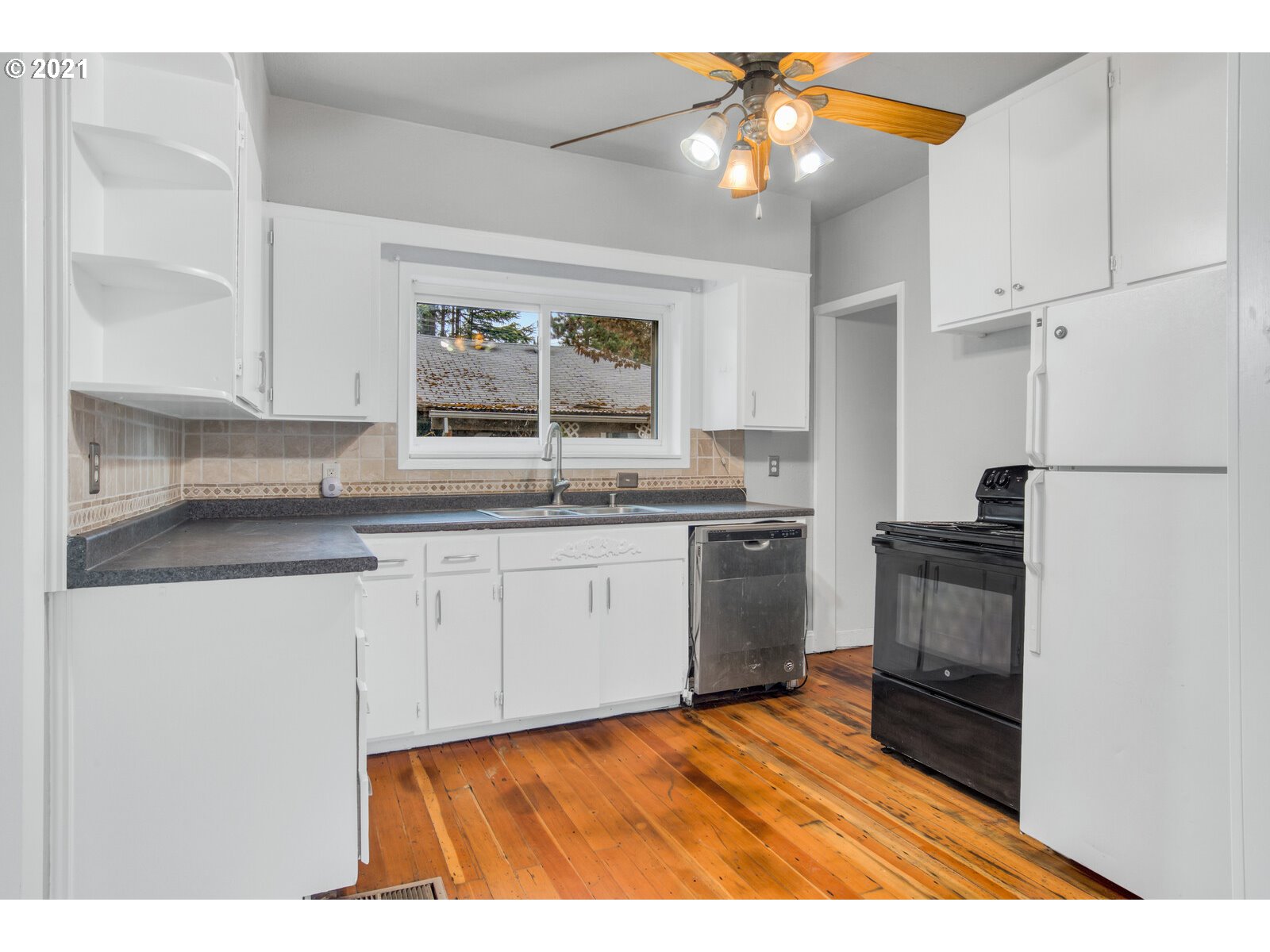 1215 2nd Street Northwest Salem, OR 97304 - Photo 14 of 32 a kitchen with granite countertop white cabinets and white appliances