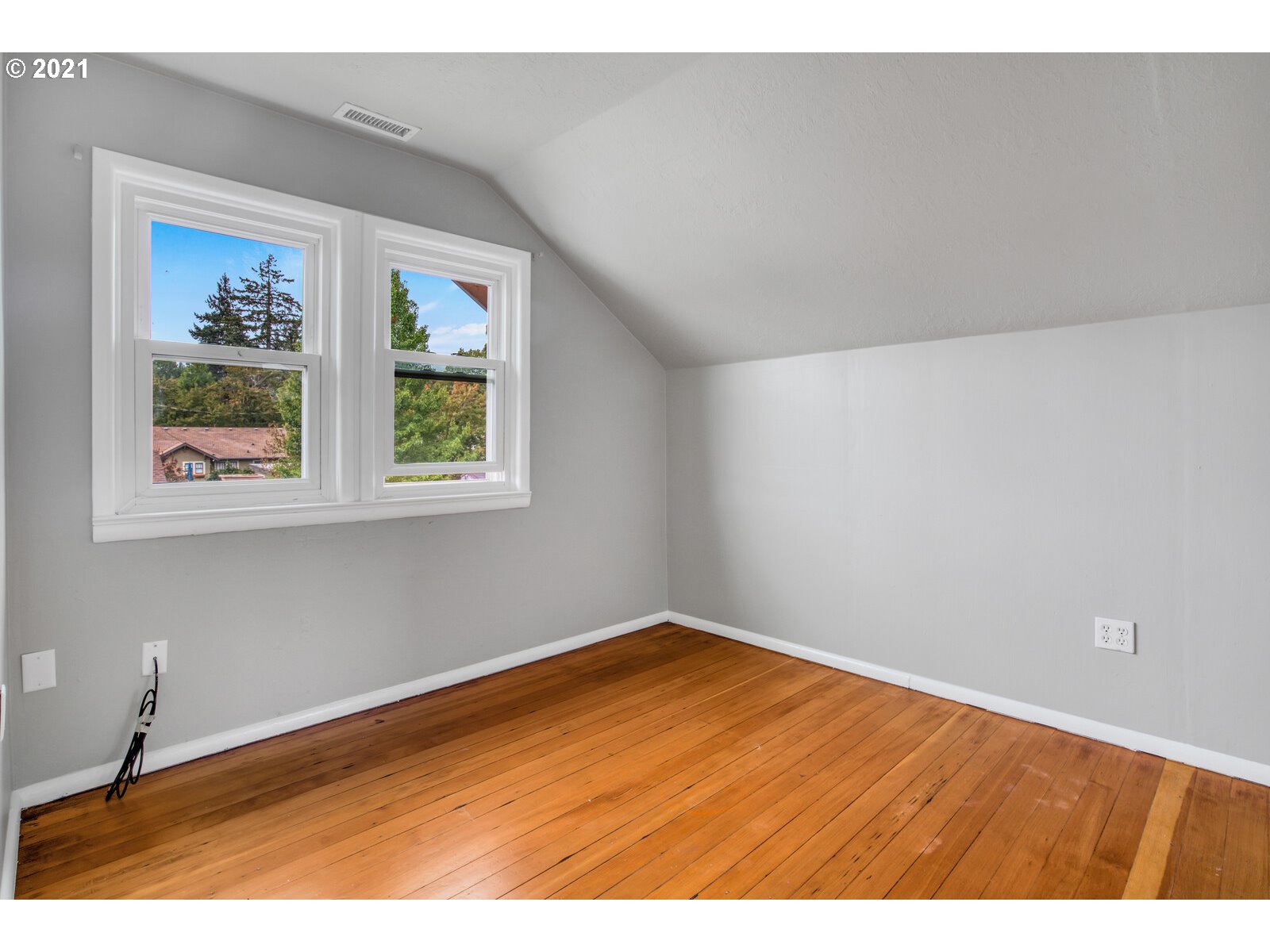 1215 2nd Street Northwest Salem, OR 97304 - Photo 18 of 32 a view of an empty room with a window and wooden floor