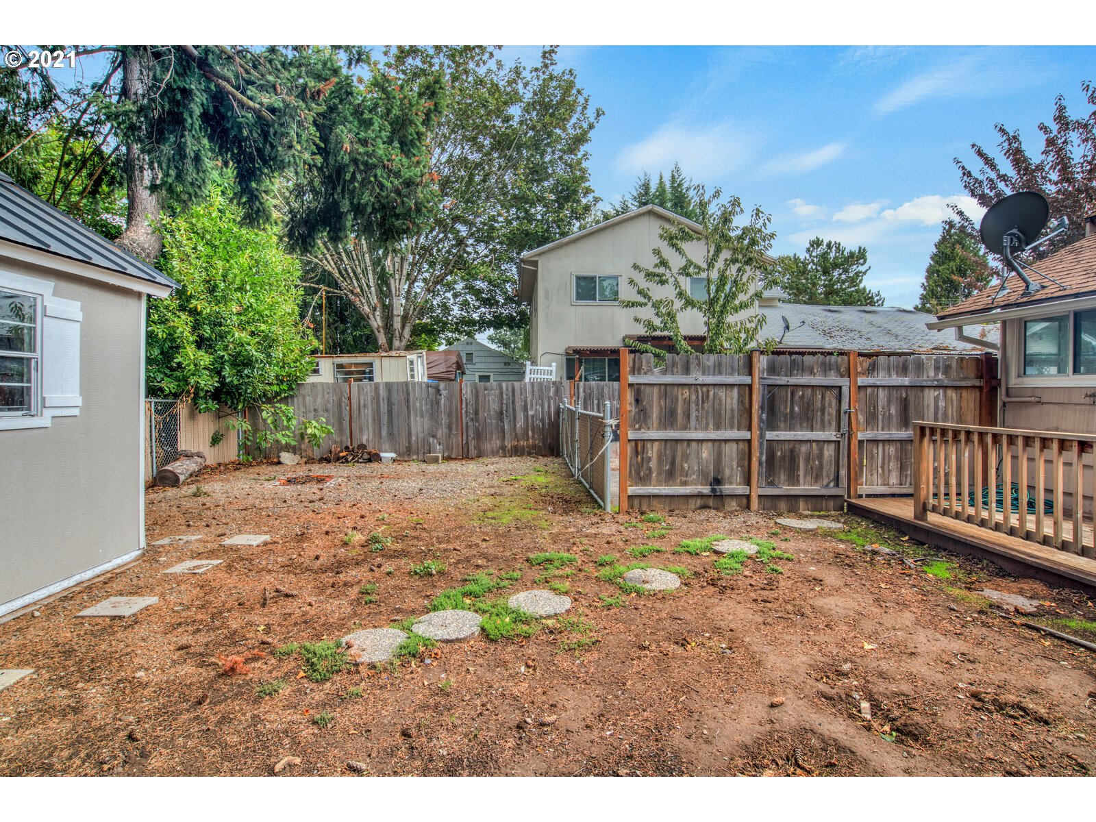 1215 2nd Street Northwest Salem, OR 97304 - Photo 31 of 32 a view of a backyard with a tree and wooden fence