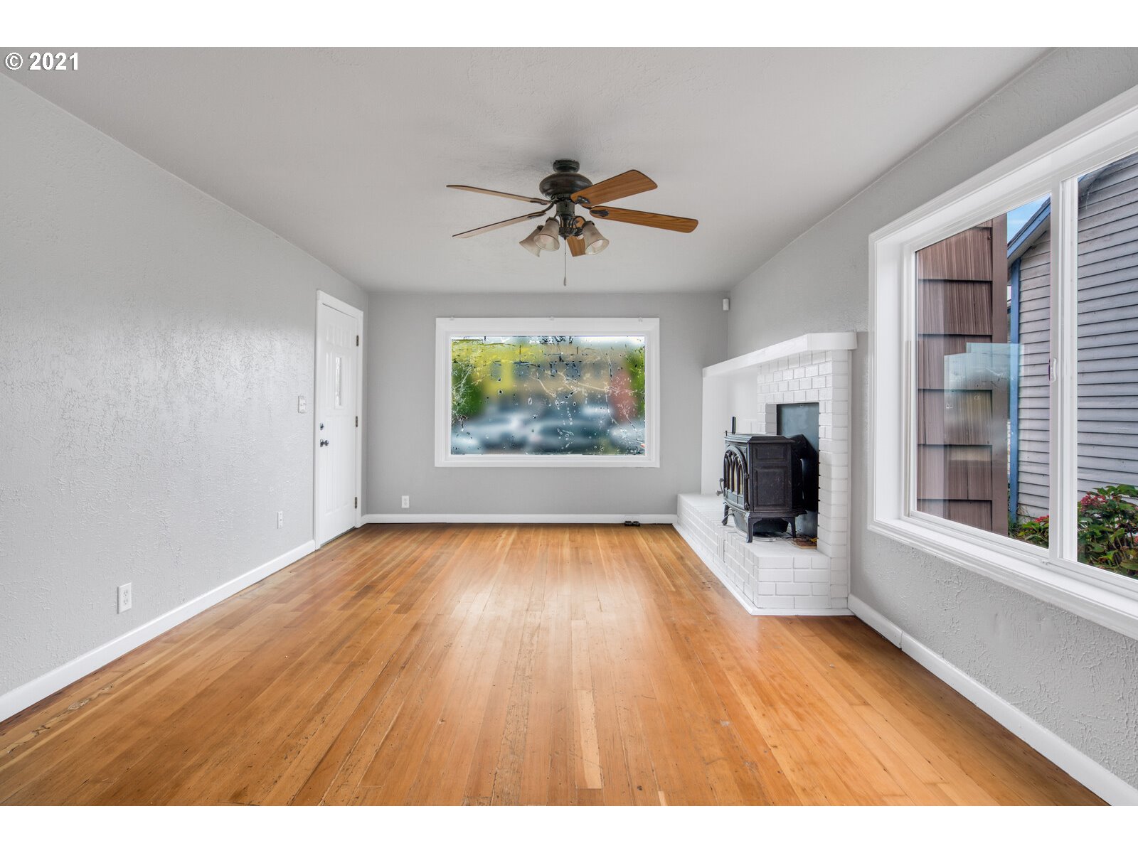 1215 2nd Street Northwest Salem, OR 97304 - Photo 5 of 32 a view of empty room with fireplace and wooden floor
