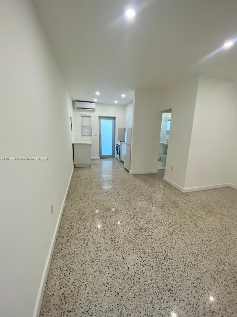 Santa Clara Miami, FL 33127 - Photo 3 of 11 an empty room with a kitchen