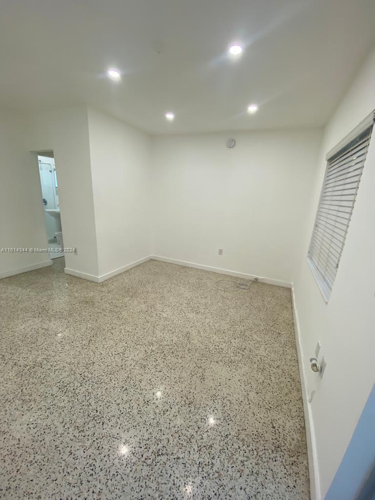 Santa Clara Miami, FL 33127 - Photo 4 of 11 an empty room with a fireplace